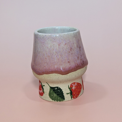 Another angle showing strawberries and leaves at the base of the cup. The pattern wraps around the cup.