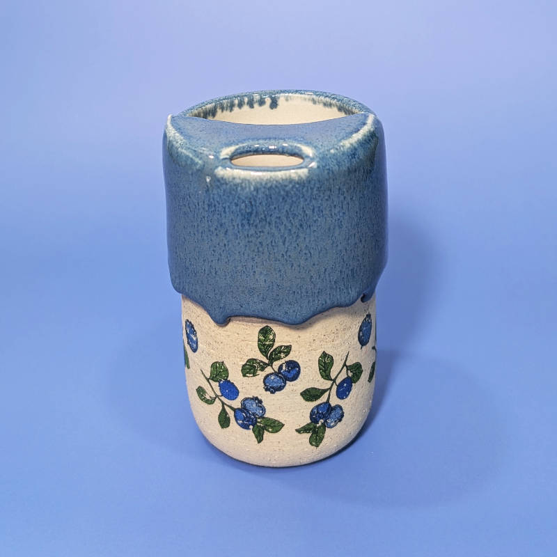 A beautiful almost denim looking blue glaze that matches the blueberry and leaf pattern on the cup.