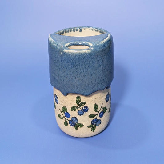 A beautiful almost denim looking blue glaze that matches the blueberry and leaf pattern on the cup.