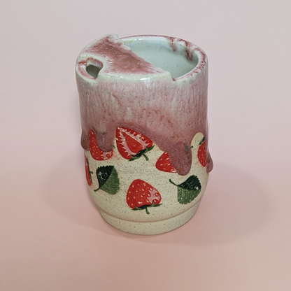 A 3 quarter view of the front and side that showcases where you can sip your tasty beverage from.