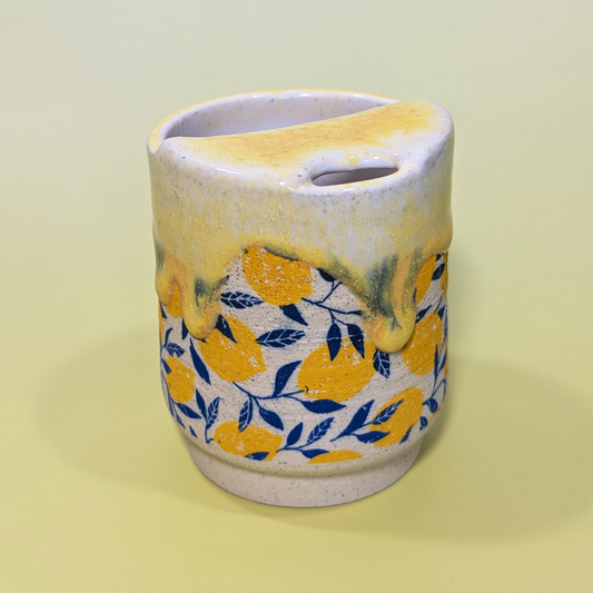 The flowing yellow glaze picks up the colors of the lemon and leaf pattern.