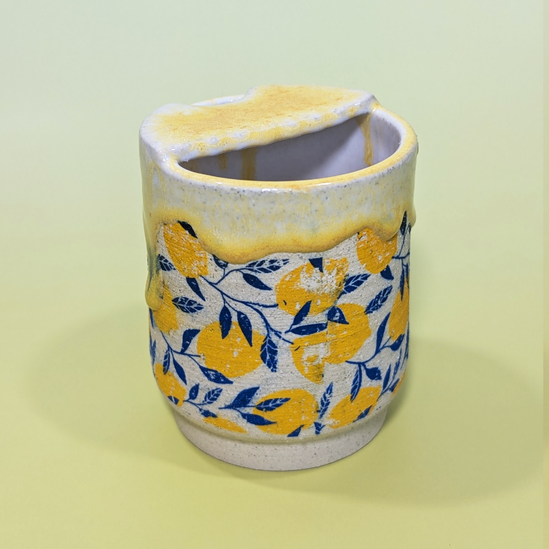 Another image of the back of the sippy cup with the lid at a slight angle.
